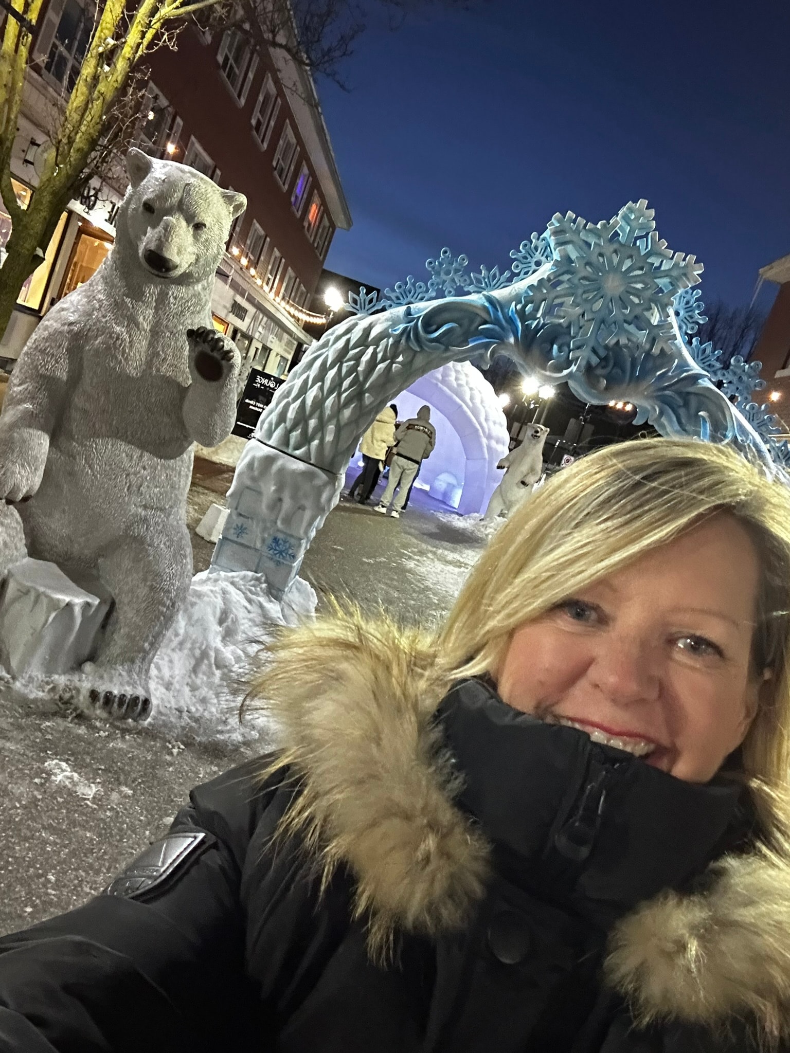 Jane Twinney at winter festival with polar bear sculptures